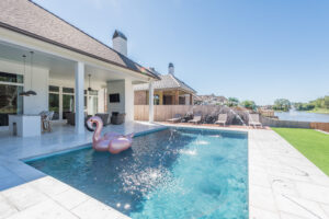 Rectangle gunite swimming pool with pink flamingo floating