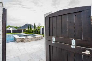 Courtyard door opening to a custom rectangle swimming pool