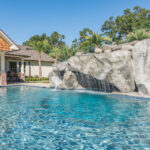 Custom rock grotto designed and built by Bask Pools in Lafayette, LA