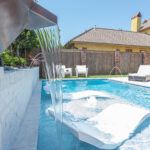 Water feature spilling over into tanning ledge