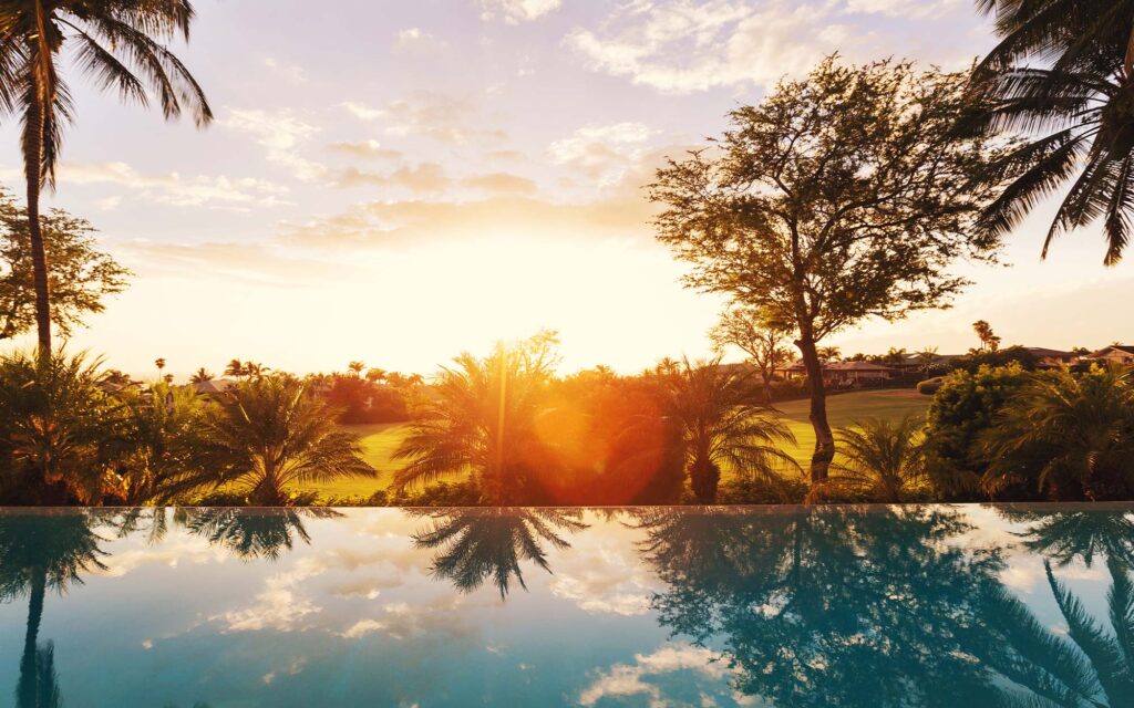 Photo overlooking a pool during sunset