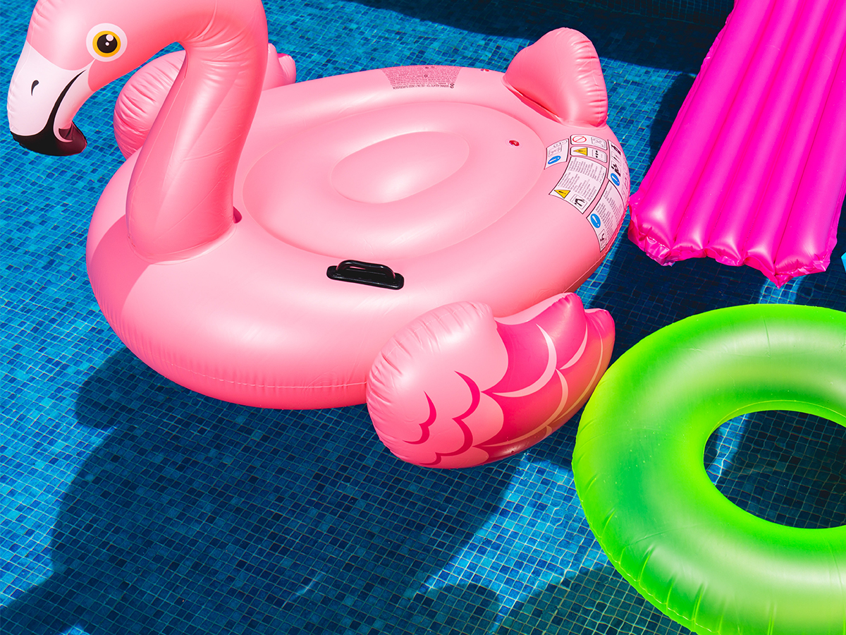 Pool full of colorful pool floats.