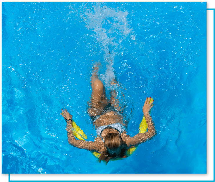 Woman floating in pool with foam noodle