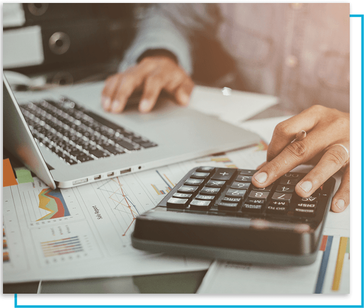 Man working with a laptop and calculator
