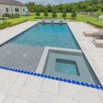 Custom swimming pool Lafayette, LA, natural stone deck, tanning ledge and sunken spa