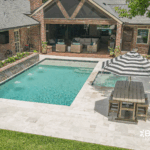 Custom-built inground pool with spa and water features by Bask Pools, a pool builder in Lafayette, LA