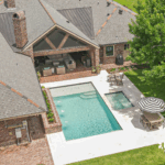 Custom-built inground pool with spa and water features by Bask Pools, a pool builder in Lafayette, LA