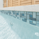 Mosiac waterline tile in a custom inground pool built by Bask Pools in Lafayette, LA