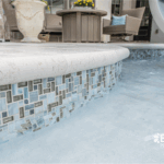 Stylish custom backyard pool with built-in umbrella, tanning ledge by Bask Pools in Lafayette, LA